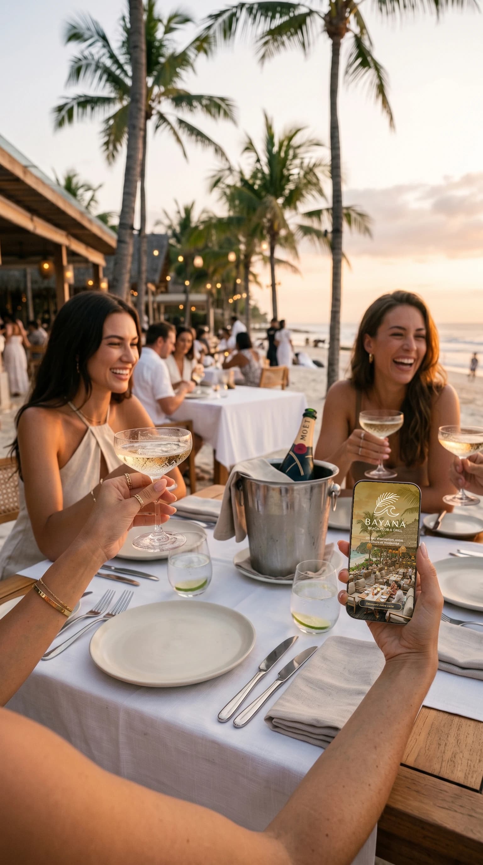 Convives scannant un menu QR au coucher du soleil dans un beach club